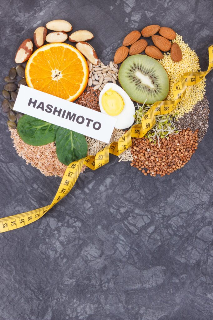 Inscription hashimoto with nutritious ingredients, fruits and vegetables in shape of thyroid