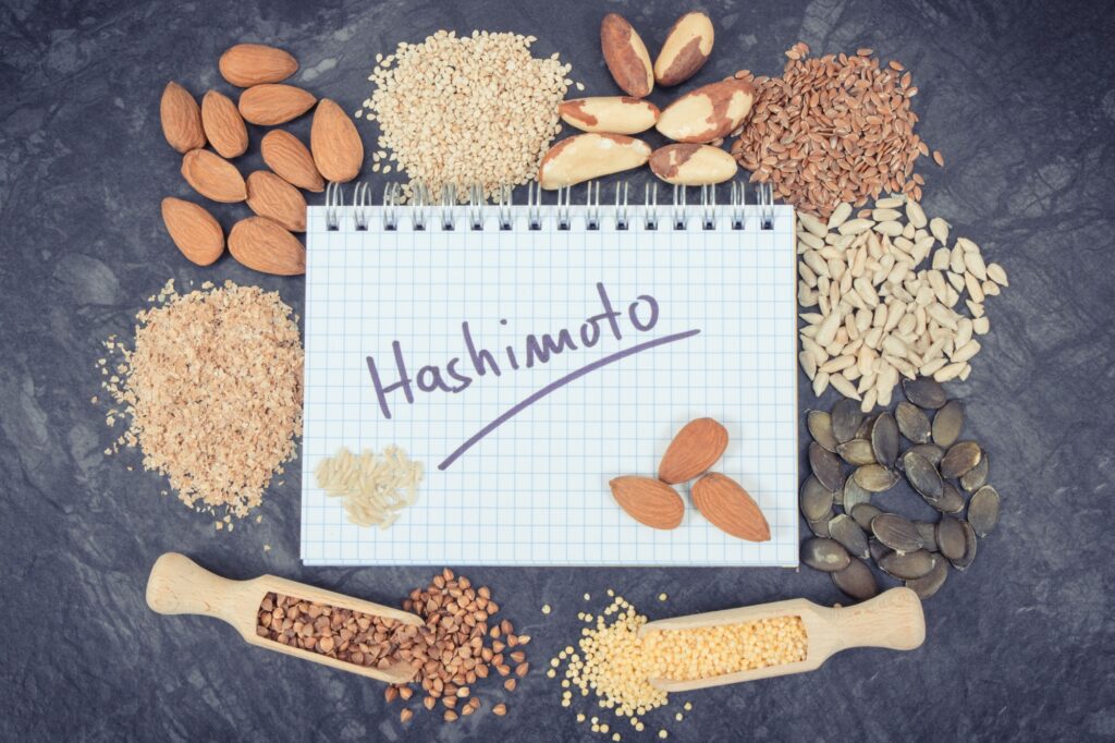 Notepad with inscription hashimoto and best ingredients or products for healthy thyroid
