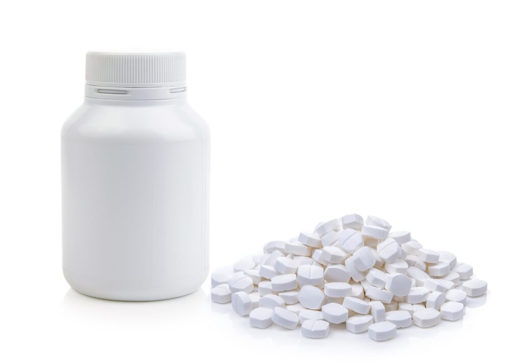 Pills spilling out of pill bottle