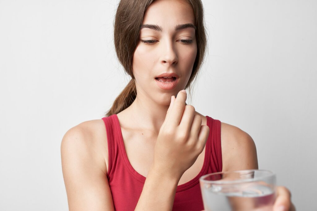 woman in red t-shirt iodine pills treatment medicine pharmacy